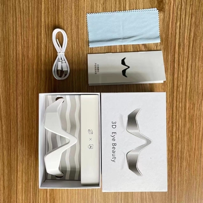 Appareil de thérapie de lumière rouge à la main pour les cernes et le masseur oculaire à micro-courant